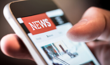 Closeup of phone displaying news feed